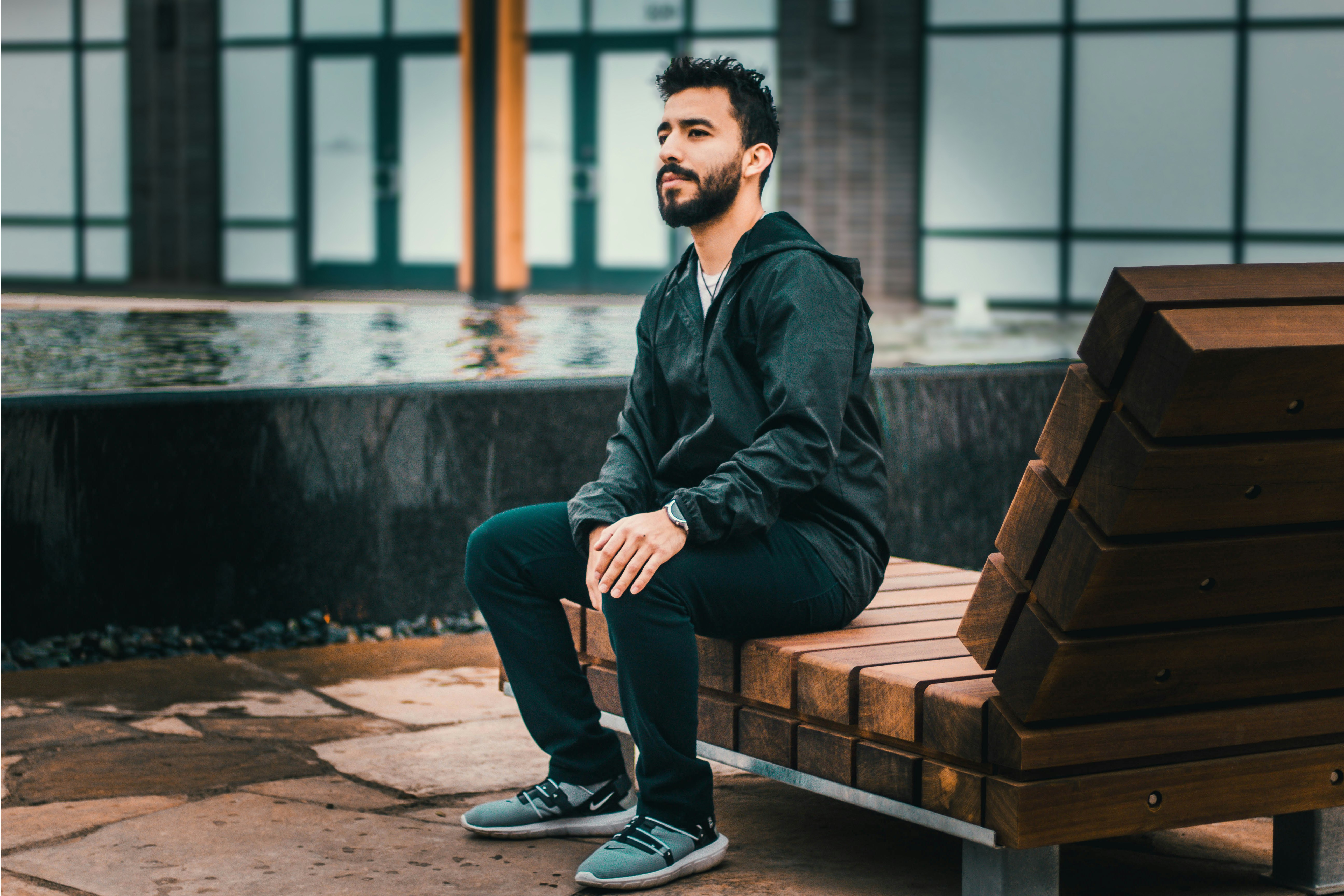 man sitting on wooden lounge